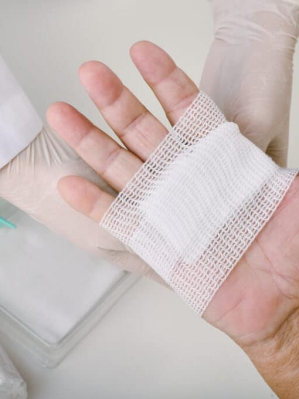 Doctor doing wound dressing care and bandaging patient's hand, Hand surgery treatment, Nurse treat patient's finger injury in hospital.